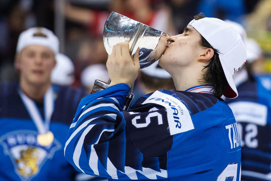 Aarne Talvitie of Finland kisses the winner's trophy