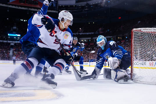 Logan Cockerill of USA in front of goaltender Ukko-Pekka
