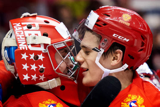 Goaltender Pyotr Kochetkov and Klim Kostin of Russia hug