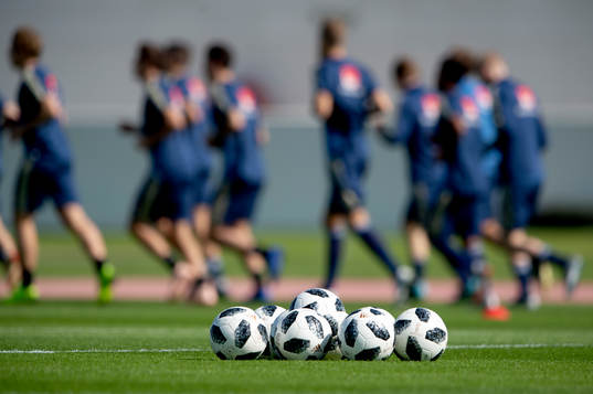 Sweden players in the background of a set of footballs