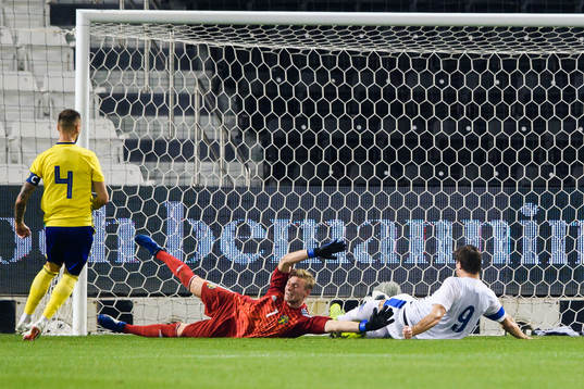 Eero Markkanen of Finland scores 0-1 behind goalkeeper
