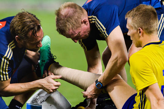 Jonathan Augustinsson of Sweden receives help