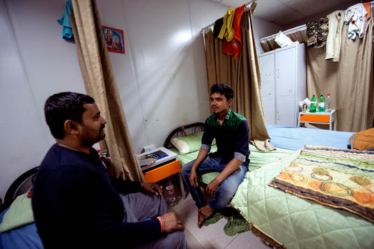 Workers Mohammad Rubel, of Bangladesh and Dilip Kumar, of