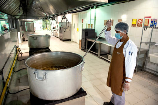 Workers in the kitchen in Challenger City, which is a