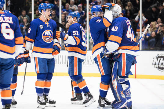 Adam Pelech and goalkeeper Robin Lehner of New York