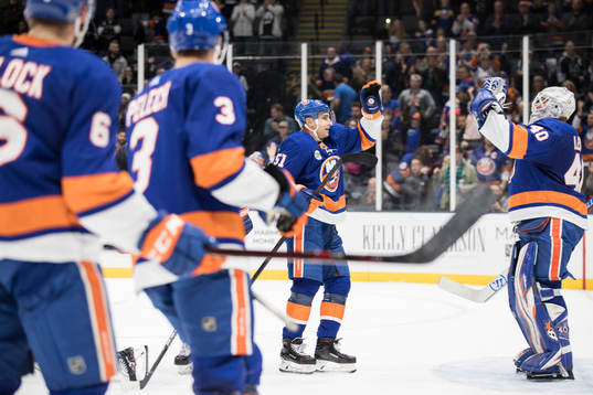 Valtteri Filppula and goalkeeper Robin Lehner celebrate