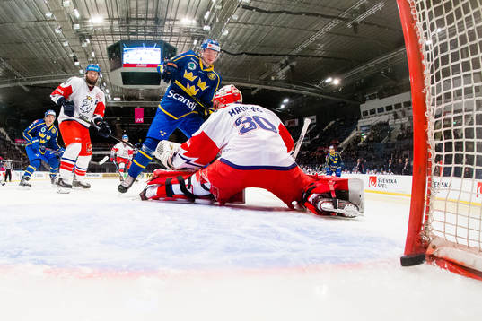 Emil Bemström of Sweden scores 0-1 behind goaltender Simon
