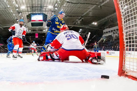 Emil Bemström of Sweden scores 0-1 behind goaltender Simon