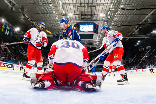 Jakob Lilja  of Sweden and goaltender Simon Hrubec of of