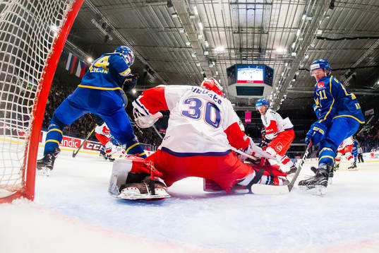 Jakob Lilja  and Joakim Nygård of Sweden and goaltender