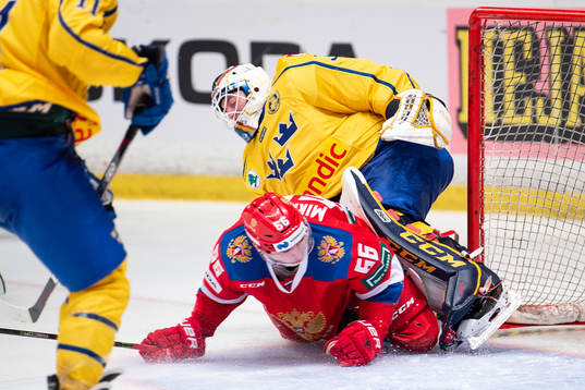 Ilia Mikheyev of Russia crashes into goaltender Adam