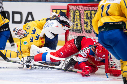 Ilia Mikheyev of Russia crashes into goaltender Adam