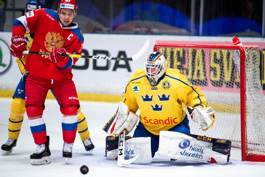 Vadim Shipachyov of Russia and goaltender Adam Reideborn of