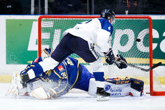 Juhani Tyrväinen of Finland and goaltender Adam Reideborn