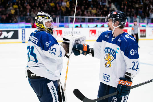Goaltender Veini Vehviläinen and Janne Pesonen of Finland