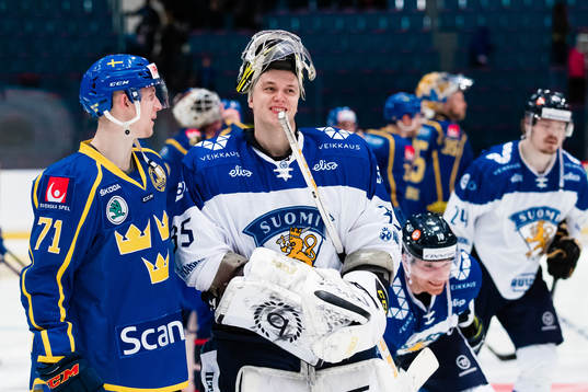 Jonathan Davidsson of Sweden and  goaltender Veini
