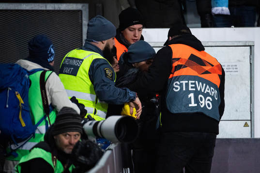 Security personel handles a pitch invader