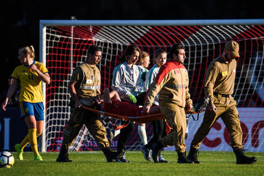 Ana Caoeta of Portugal is carried of the pitch