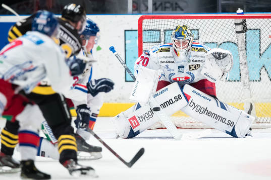 Oskarshamns målvakt Adam Åhman följer pucken