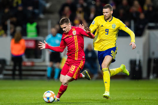 Razvan Marin of Romania and Marcus Berg of Sweden competes