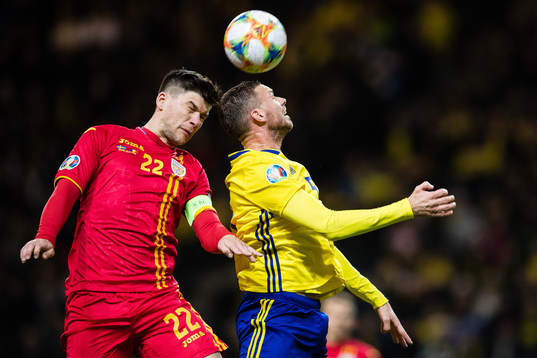 Cristian Sapunaru of Romania nd Marcus Berg of Sweden