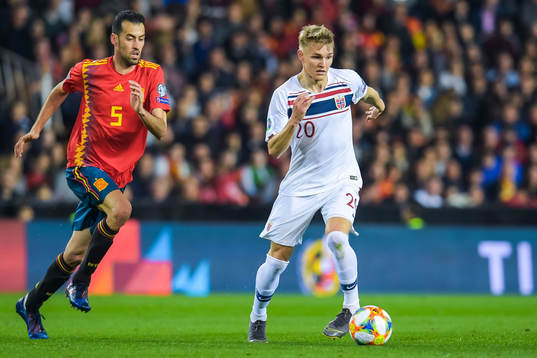 Sergio Busquets of Spain and Martin Ødegaard of Norway