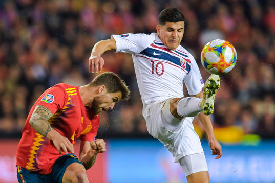 Inigo Martinez Berridi of Spain and Tarik Elyounoussi of