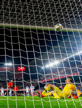 Sergio Ramos of Spain scores 2-1 behind goalkeeper Rune