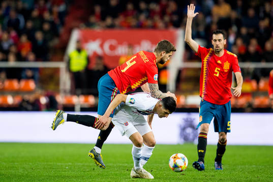 Inigo Martinez Berridi of Spain and Tarik Elyounoussi of
