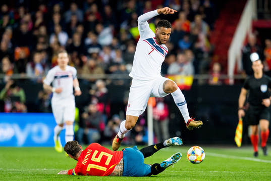 Sergio Ramos of Spain and Joshua King of Norway