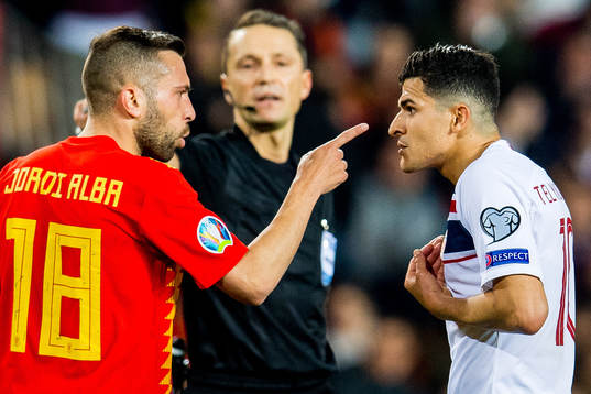 Jordi Alba of Spain and Tarik Elyounoussi of Norway argue