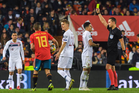 Tarik Elyounoussi of Norway receives a yellow card