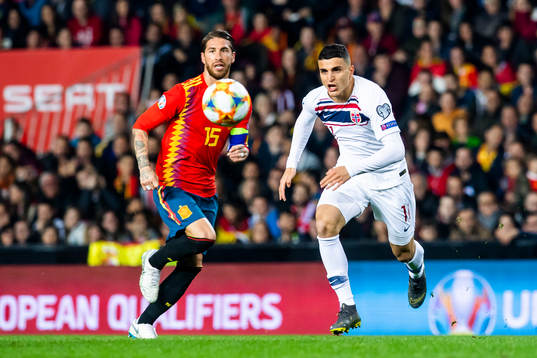 Sergio Ramos of Spain and Mohamed Elyounoussi of Norway
