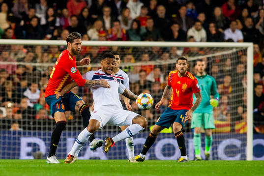 Sergio Ramos of Spain and Joshua King of Norway