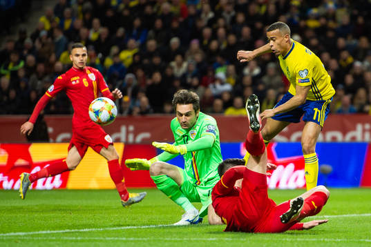 Robin Quaison of Sweden against goalkeeper Ciprian