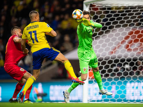 Robin Quaison of Sweden challenges goalkeeper Ciprian