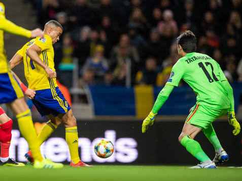 Robin Quaison of Sweden scores 1-0 behind goalkeeper