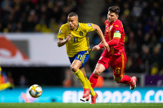 Robin Quaison of Sweden and Cristian Sapunaru of Romania
