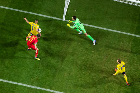 Robin Quaison of Sweden scores 1-0 behind goalkeeper