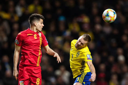 Ianis Hagi of Romania and Sebastian Larsson of Sweden