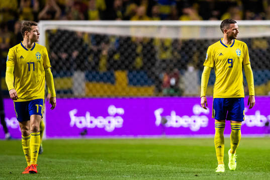 Viktor Claesson  and Marcus Berg of Sweden look dejected