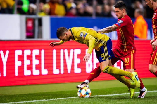 Marcus Berg of Sweden and Nicolae Stanciu of Romania