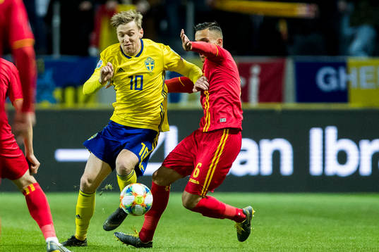 Emil Forsberg of Sweden in a duel with Cristian Manea of