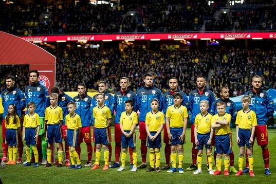 Players of Romania with mascots ahead the UEFA Euro