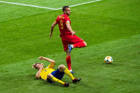 Filip Helander of Sweden falls in a duel with George Puscas