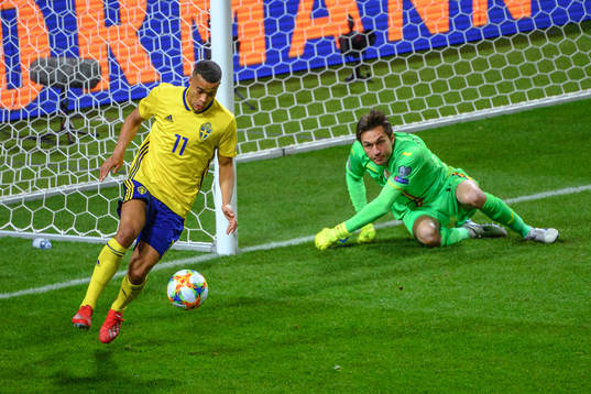 Robin Quaison of Sweden and goalkeeper Ciprian Tatarusanu