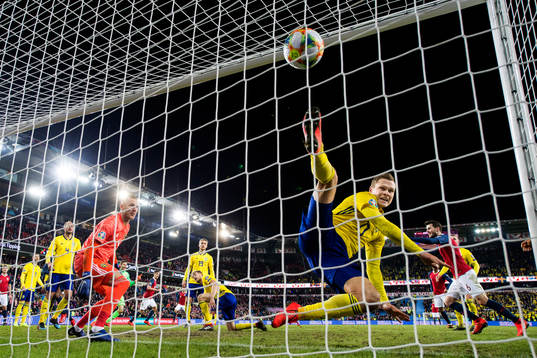 Viktor Claesson of Sweden tries to save when Ola Kamara of