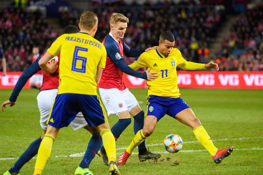 Martin Ødegaard of Norway in action with Robin Quaison of