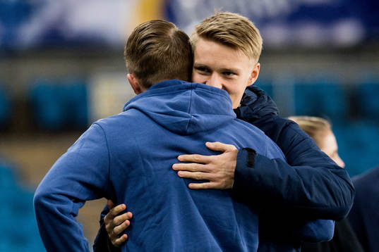 Martin Ødegaard of Norway and Sam Larsson of Sweden hug