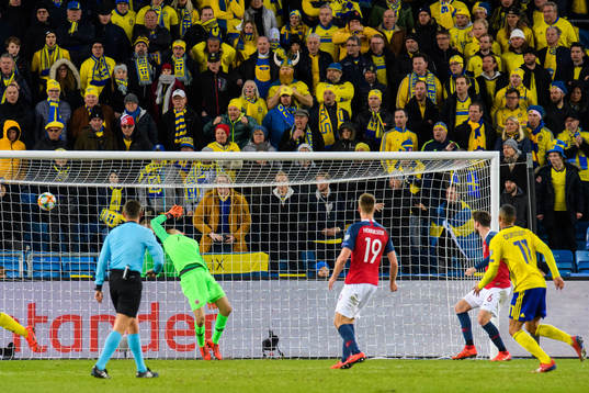 Robin Quaison of Sweden scores the 2-2 goal behind
